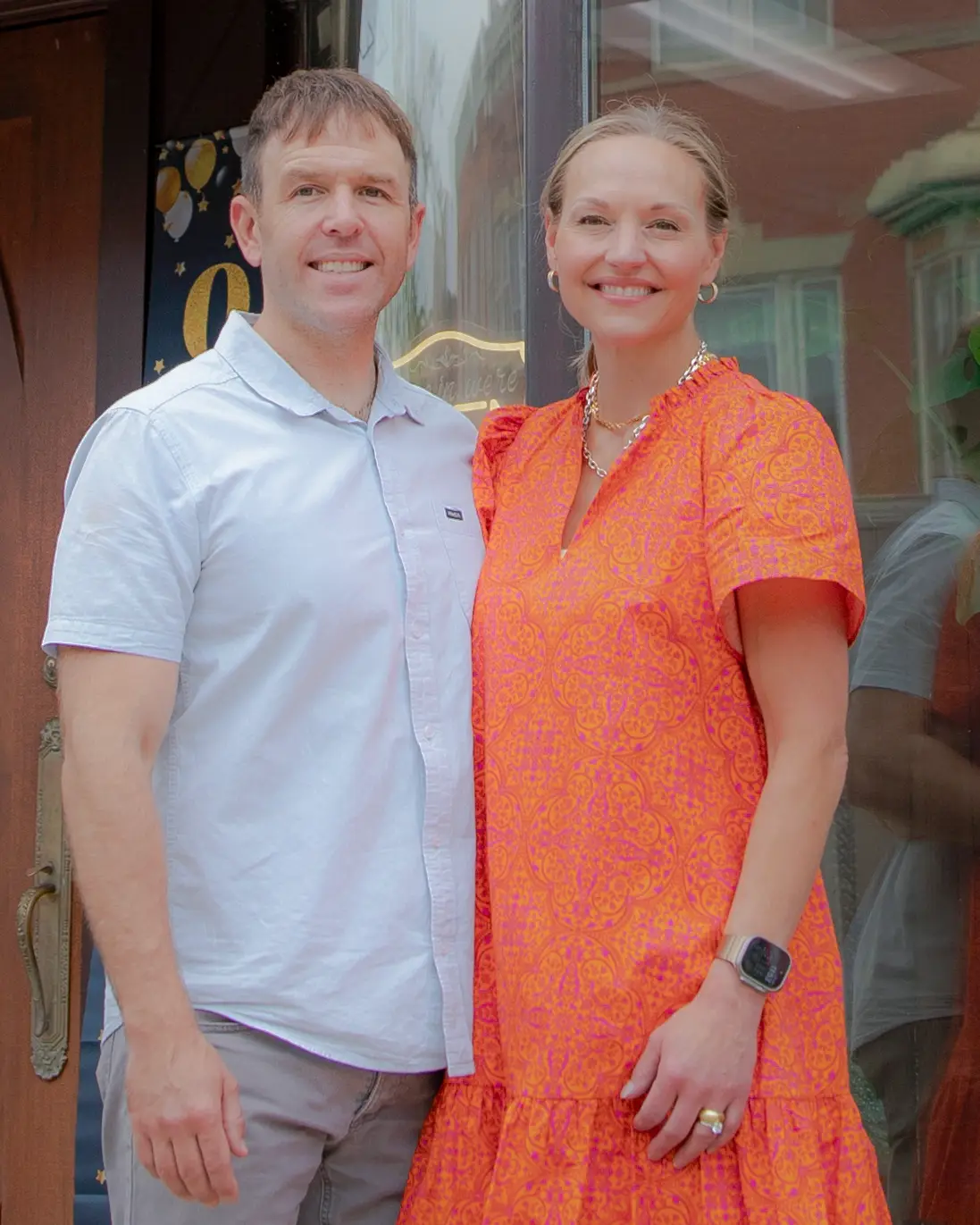 owners in front of store
