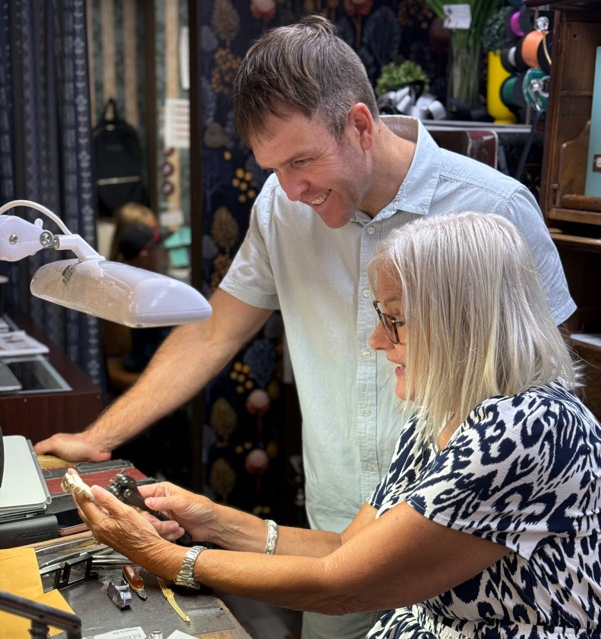 two people working on a watch repair